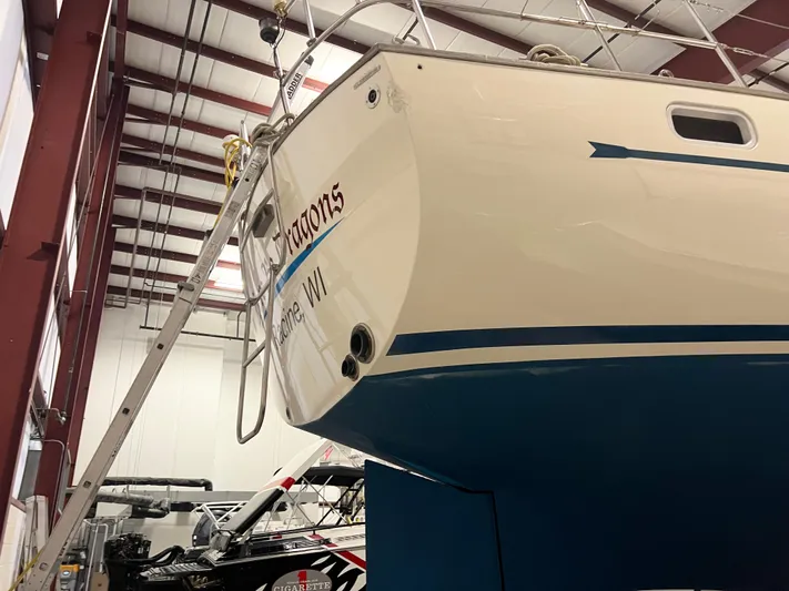 Here Be Dragons Yacht Photos Pics 1987 Oyster 46.5 sailboat in indoor storage, showcasing hull and stern details.