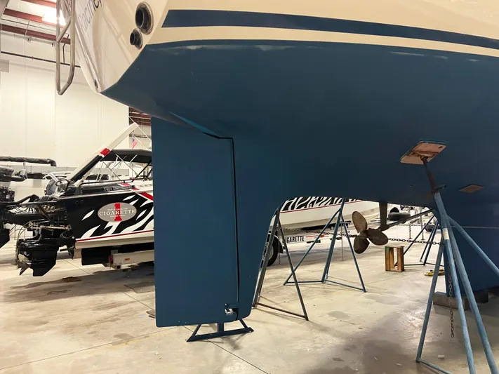 Here Be Dragons Yacht Photos Pics 1987 Oyster 46.5 sailboat in a workshop, showing keel and propeller.