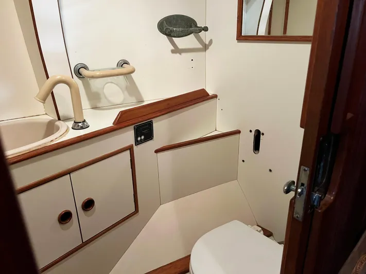 Here Be Dragons Yacht Photos Pics Interior of 1987 Oyster 46.5 yacht bathroom with sink and toilet.