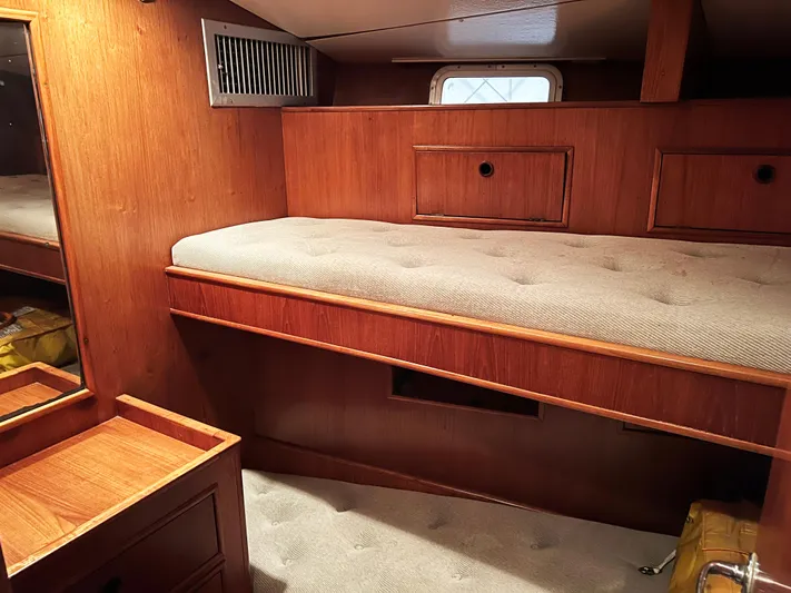 Here Be Dragons Yacht Photos Pics Cozy cabin interior of 1987 Oyster 46.5 yacht with wooden furnishings and a single bed.