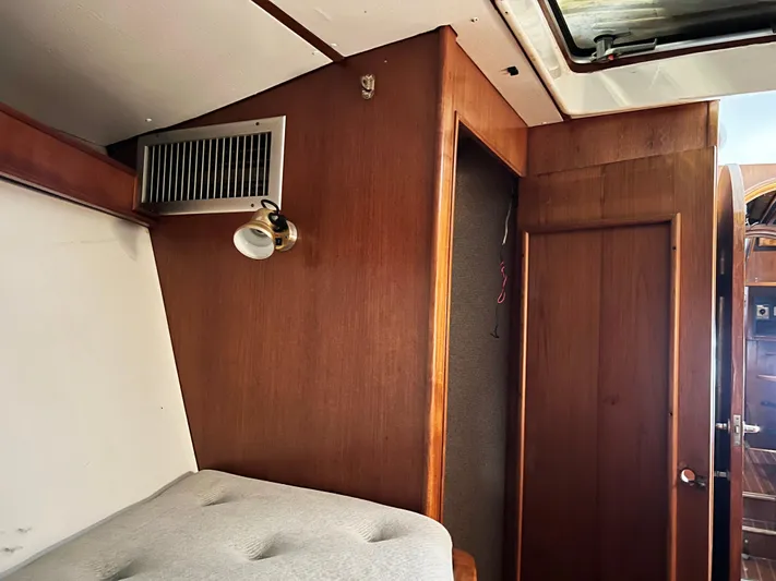 Here Be Dragons Yacht Photos Pics Interior of 1987 Oyster 46.5 yacht with wood paneling and cozy cabin space.