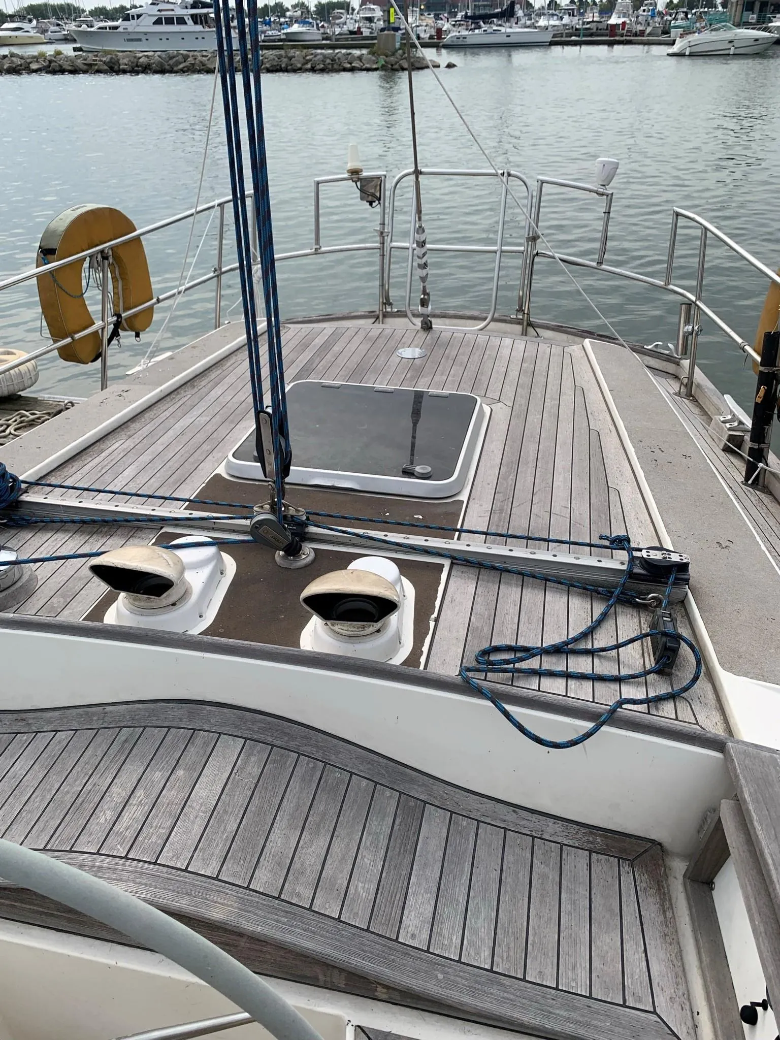 1987 Oyster 46.5 sailboat deck with wooden finish, docked at marina.