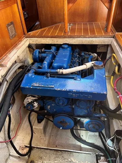 Here Be Dragons Yacht Photos Pics 1987 Oyster 46.5 sailboat engine compartment with blue engine and wiring.