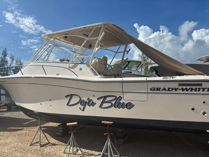  Yacht Photos Pics Grady-White Express 330 boat, 2023 model, on stands, blue sky.