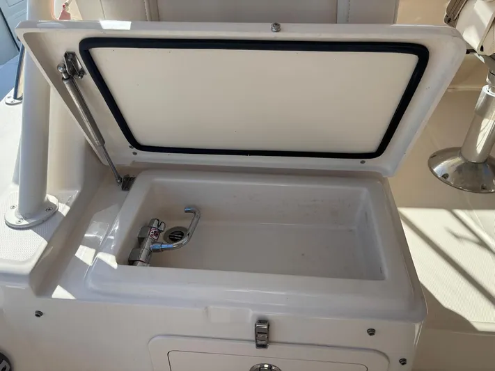  Yacht Photos Pics Grady-White Express 330 2023, open storage compartment with faucet.