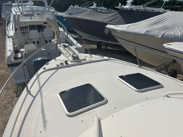  Yacht Photos Pics Grady-White Express 330 boat, 2023 model, parked at a boatyard.