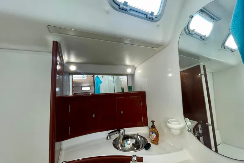 Caravan Yacht Photos Pics Bathroom interior of 2003 Beneteau First 47.7 yacht with sink and mirror.