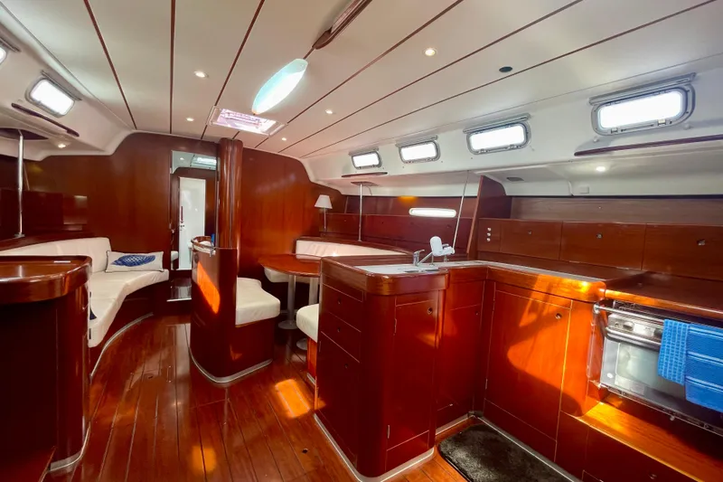 Caravan Yacht Photos Pics Luxurious interior of 2003 Beneteau First 47.7 yacht with polished wood and modern amenities.