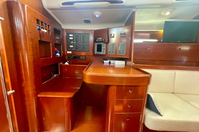 Caravan Yacht Photos Pics Luxurious interior of 2003 Beneteau First 47.7 sailboat with navigation station.
