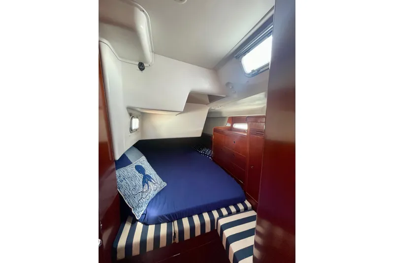 Caravan Yacht Photos Pics Cozy cabin interior of 2003 Beneteau First 47.7 sailboat with nautical decor.