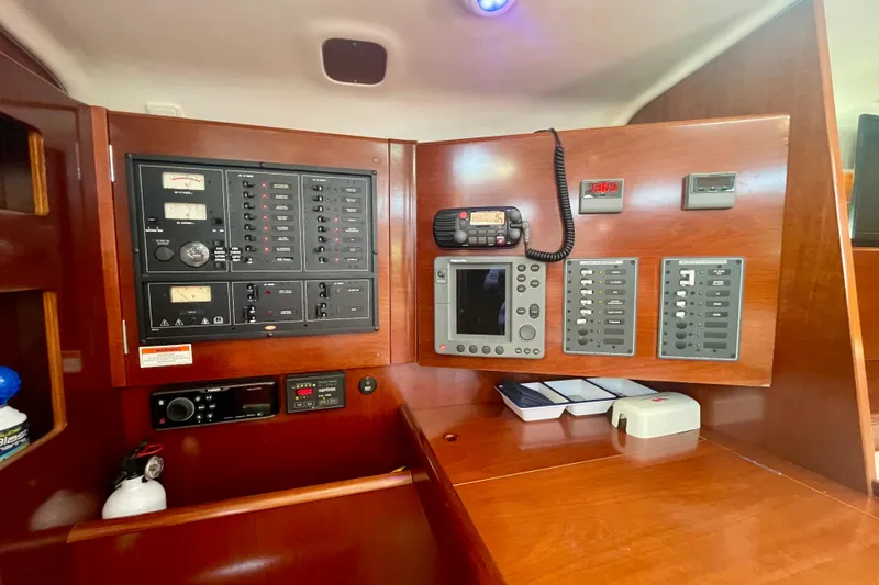 Caravan Yacht Photos Pics Control panel of a 2003 Beneteau First 47.7 yacht, featuring navigation and communication equipment.