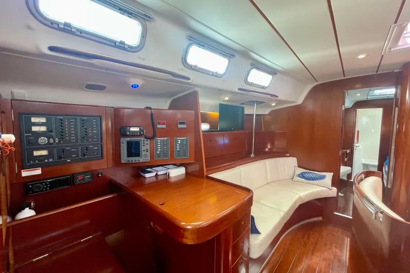 Caravan Yacht Photos Pics Interior of 2003 Beneteau First 47.7 yacht with navigation panel and seating area.