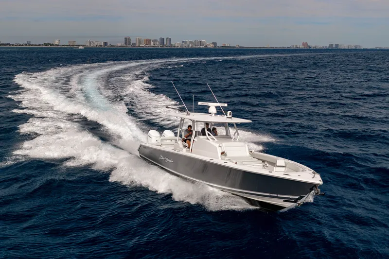  Yacht Photos Pics Jupiter 40 boat 2023 cruising on open sea with city skyline.