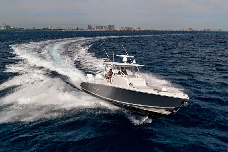  Yacht Photos Pics Jupiter 40 boat 2023 cruising on open sea with city skyline.