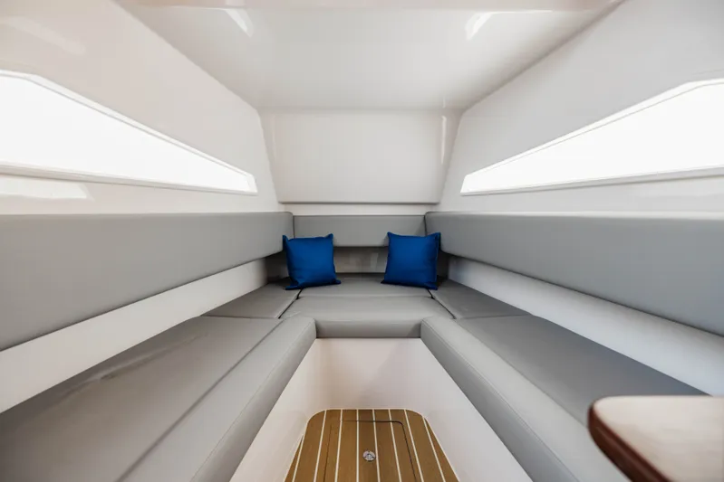  Yacht Photos Pics Interior of 2023 Jupiter 40 yacht with gray seating and blue cushions.