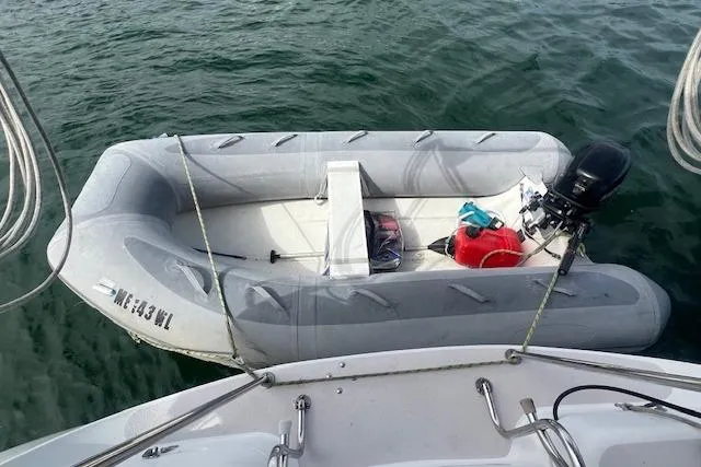 Optimistic Yacht Photos Pics Inflatable dinghy moored beside a 2003 Catalina 470 Sloop With Wing Keel.