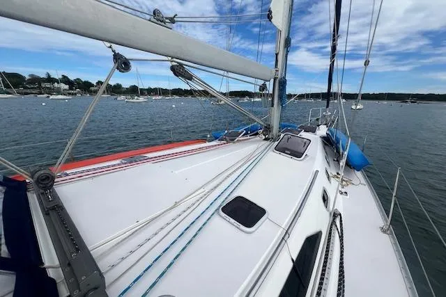 Optimistic Yacht Photos Pics 2003 Catalina 470 Sloop with Wing Keel sailing on a calm lake under blue skies.