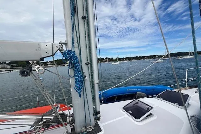 Optimistic Yacht Photos Pics 2003 Catalina 470 Sloop with Wing Keel sailing in a serene harbor.