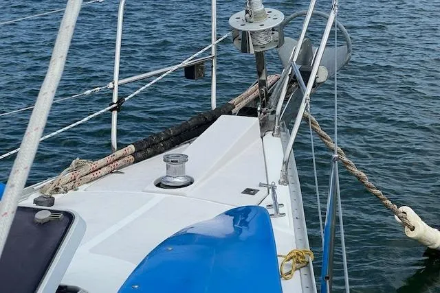 Optimistic Yacht Photos Pics 2003 Catalina 470 Sloop with wing keel, deck view, sailing on calm waters.