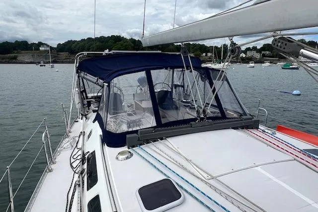 Optimistic Yacht Photos Pics 2003 Catalina 470 Sloop with wing keel, docked in a serene harbor setting.