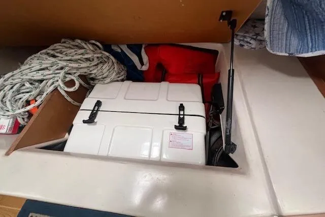 Optimistic Yacht Photos Pics Storage compartment in 2003 Catalina 470 Sloop with ropes, life jackets, and equipment.