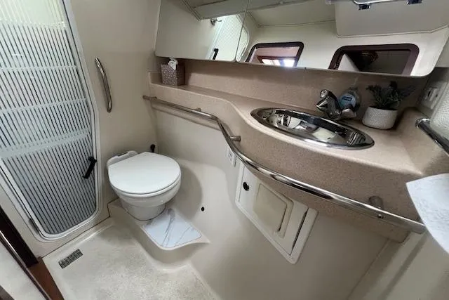 Optimistic Yacht Photos Pics Bathroom interior of 2003 Catalina 470 Sloop, featuring toilet, sink, and shower area.