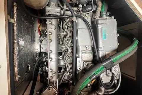 Optimistic Yacht Photos Pics Engine compartment of a 2003 Catalina 470 Sloop with Wing Keel, featuring visible hoses and components.