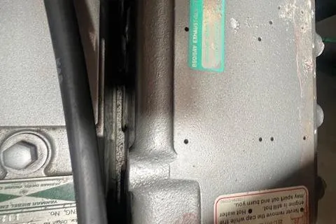 Optimistic Yacht Photos Pics Close-up of a 2003 Catalina 470 Sloop engine component with visible labels and cables.