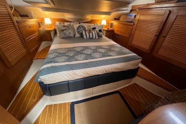 Optimistic Yacht Photos Pics Luxurious 2003 Catalina 470 Sloop cabin with cozy bed and elegant wood finish.
