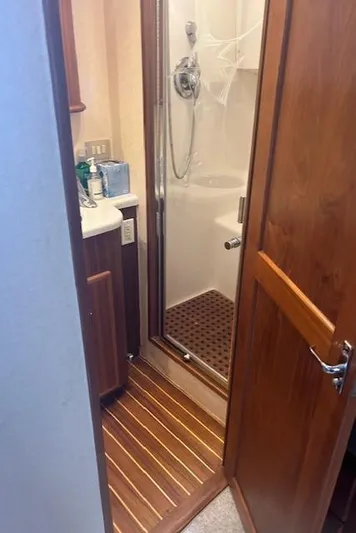  Yacht Photos Pics 2006 Topaz 40 Express yacht bathroom with wooden flooring and enclosed shower.