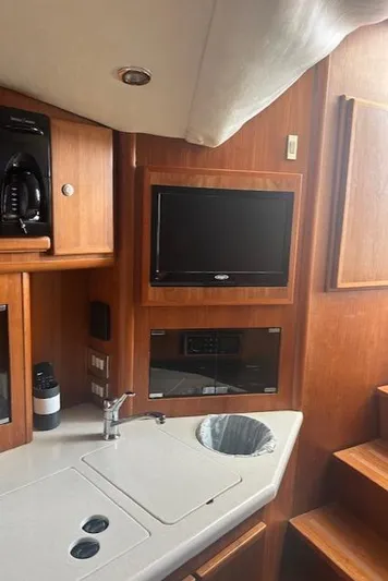  Yacht Photos Pics 2006 Topaz 40 Express yacht interior with TV and kitchenette.