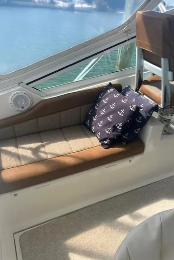  Yacht Photos Pics Interior seating area of a 2006 Topaz 40 Express boat with nautical-themed cushions.