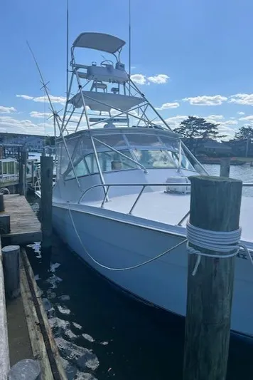  Yacht Photos Pics 2006 Topaz 40 Express boat docked at a marina on a sunny day.