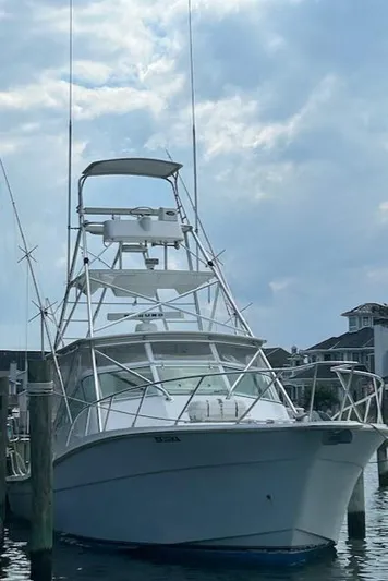  Yacht Photos Pics 2006 Topaz 40 Express boat docked at a marina under a cloudy sky.