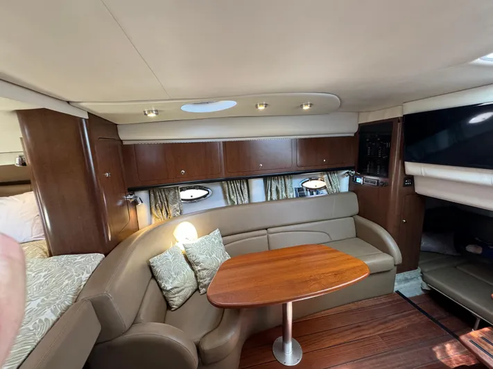  Yacht Photos Pics Interior of 2018 Crownline 350 SY yacht with cozy seating and wooden table.