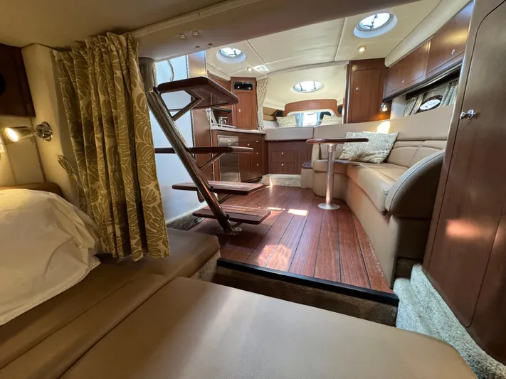  Yacht Photos Pics Luxurious interior of 2018 Crownline 350 SY yacht with elegant wood finishes and cozy seating.