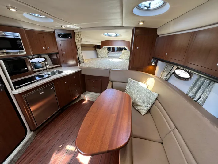  Yacht Photos Pics Luxurious interior of 2018 Crownline 350 SY yacht with kitchen, seating, and bed.