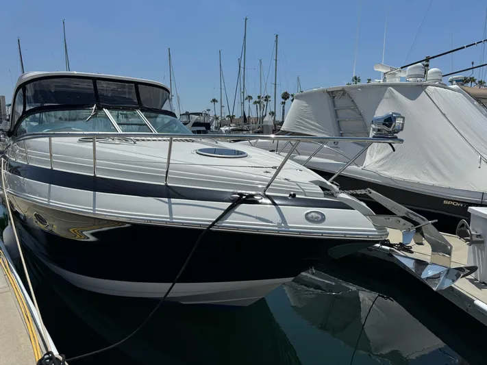  Yacht Photos Pics 2018 Crownline 350 SY yacht docked at marina, clear sky, calm water.