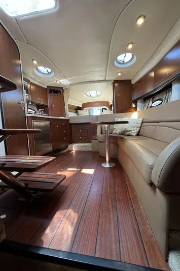  Yacht Photos Pics 2018 Crownline 350 SY yacht interior with elegant wood flooring and modern furnishings.