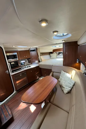  Yacht Photos Pics 2018 Crownline 350 SY yacht interior with kitchen, dining area, and bed.