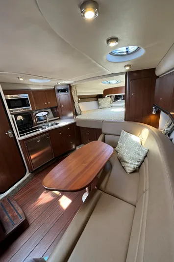  Yacht Photos Pics 2018 Crownline 350 SY yacht interior with kitchen, seating, and sleeping area.
