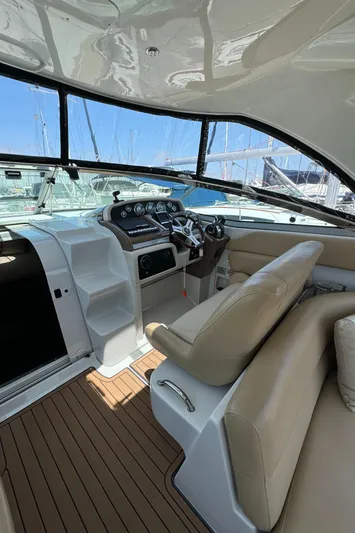 Yacht Photos Pics 2018 Crownline 350 SY yacht cockpit with beige seating and modern dashboard.
