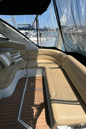  Yacht Photos Pics 2018 Crownline 350 SY yacht interior with beige seating and wooden flooring.