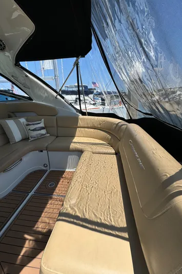  Yacht Photos Pics 2018 Crownline 350 SY yacht interior with beige seating and wooden flooring.