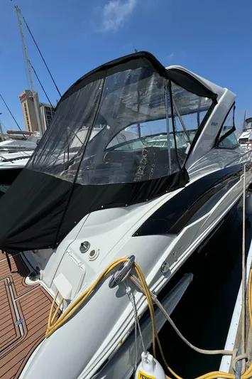  Yacht Photos Pics 2018 Crownline 350 SY yacht docked, featuring sleek design and modern canopy under clear blue sky.