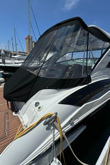 Yacht Photos Pics 2018 Crownline 350 SY yacht docked, featuring sleek design and protective canopy.