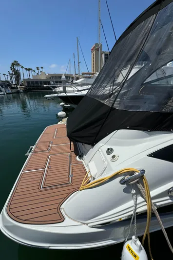  Yacht Photos Pics 2018 Crownline 350 SY yacht docked in marina, featuring sleek design and spacious deck.