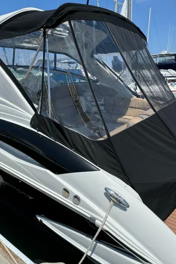  Yacht Photos Pics 2018 Crownline 350 SY boat with sleek design and black canopy in marina.