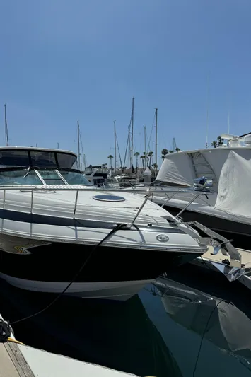  Yacht Photos Pics 2018 Crownline 350 SY yacht docked in a marina under clear blue skies.