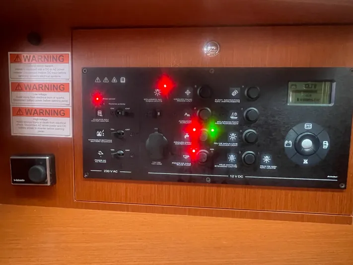 Danmark Yacht Photos Pics Control panel of a 2019 Beneteau Oceanis 41.1 yacht with warning labels and switches.
